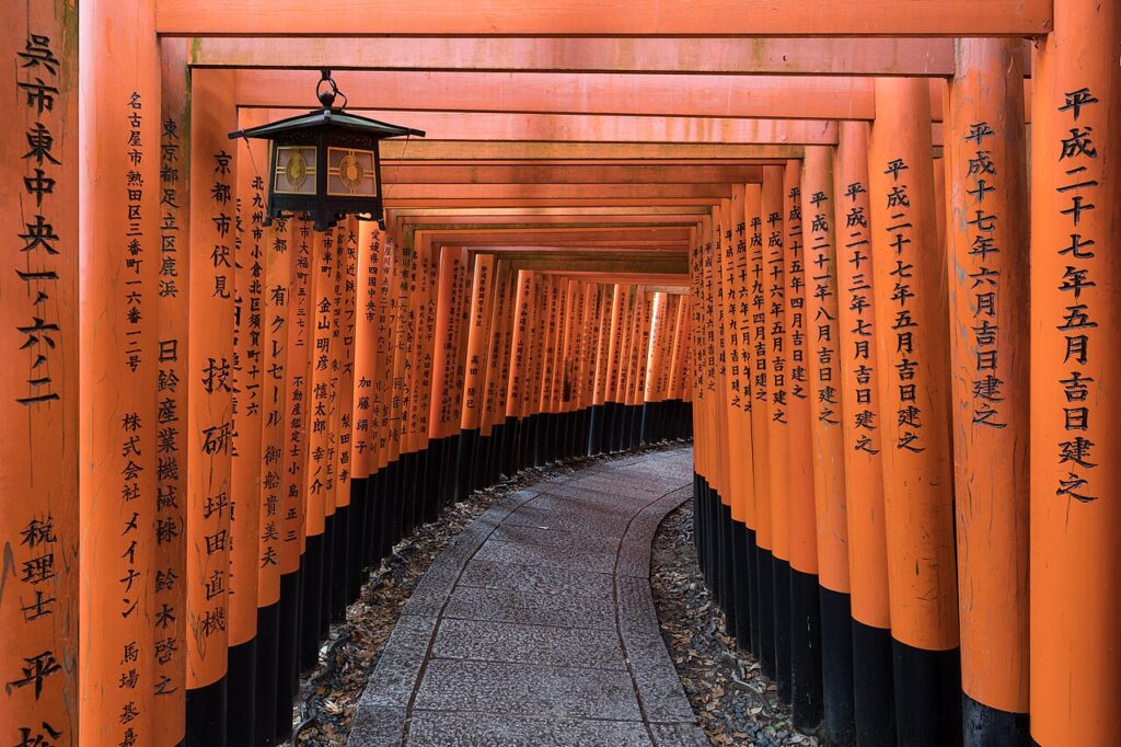 Torii path with lantern at Fushimi Inari Taisha Shrine, Kyoto, Japan